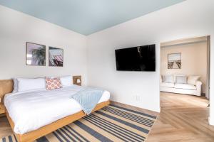 维尼瑟恩魁北克Hôtel le Rosay的一间卧室配有一张床和一台平面电视