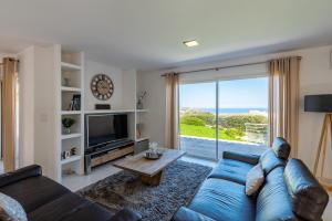 蒙蒂塞洛Villa Acula的客厅配有蓝色的沙发和电视