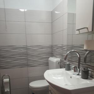 苏提万Apartman Sutivan的白色的浴室设有卫生间和水槽。