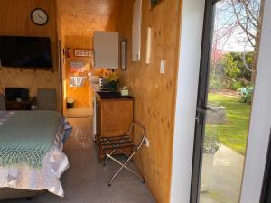 莫图伊卡Glenwai的一间卧室配有一张床、一张书桌和一个窗户。