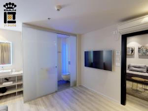 特拉维夫Link Hotel & Hub By Dan Hotels的一间带卫生间的浴室和墙上的电视