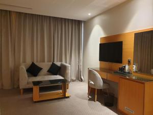吉达Al Rayyan Tower的酒店客房配有椅子、书桌和电视