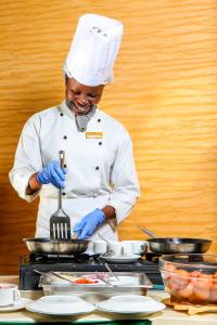 内罗毕韦斯顿酒店的厨师在锅里拿着叉子
