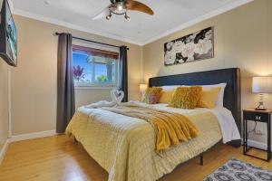 劳德代尔堡Waterfront Luxury Villa with Heated Pool, Deck, BBQ的一间卧室配有一张带黄色毯子和窗户的床