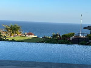 努沙杜瓦巴厘岛私人别墅 的一座背景海洋的游泳池