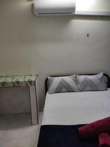 瓜拉丁加奴CiTY Homestay Budget 2bedrooms Midtown Kuala Terengganu的卧室配有白色的床和桌子