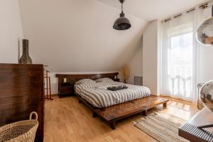 圣阿波利奈尔Charmante Maison Climatisée avec son Jardin à 5 minutes de DIJON的一间卧室配有一张床和一张木桌