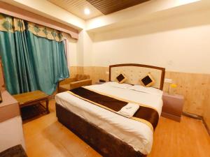 西姆拉Shorya Regency的一间卧室配有一张带绿色窗帘的大床