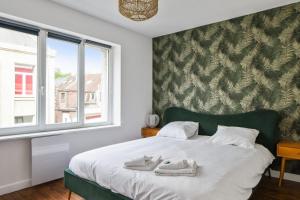 里尔Beautiful apartment near the Wazemmes market - Lille - Welkeys的一间卧室配有一张床,上面有两条毛巾