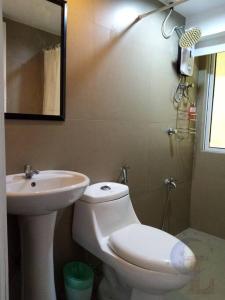马尼拉2 BR loft-type condo Fort Victoria的一间带水槽、卫生间和镜子的浴室