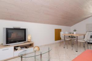 格鲁达Apartments and rooms by the sea Molunat, Dubrovnik - 9102的客厅配有电视和桌子