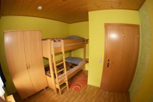 ReisachHaus Stöffler的一间小房间,配有双层床和一扇门