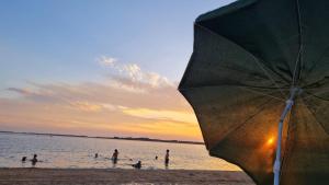 圣格雷戈里奥德波兰科Afecto的一群人在海滩上,带一把遮阳伞