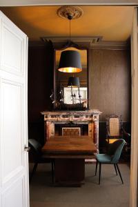 安特卫普Huis Dujardin Bed&Breakfast的一间带桌子和壁炉的用餐室