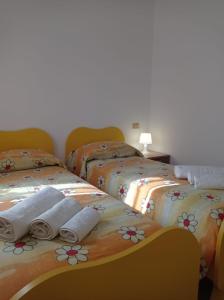 佩特拉利亚索普拉纳Casa Vacanze Borgo Gulini da Anna的两张床并在一起,配有毛巾
