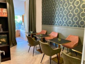 南特Hôtel Coeur De Loire的一间餐厅,房间内设有四张桌子和椅子