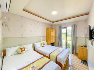Liên Trì (4)Khách sạn Triều Dâng的酒店客房设有两张床和电视。