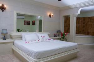 蓬塔卡纳Aparthotel Castillo Real的卧室配有白色的床和浴缸
