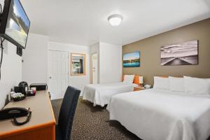 国王海滩Crown Motel的酒店客房配有两张床和一张书桌