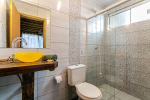普腊亚罗萨Moradas do Vale Praia do Rosa的一间带黄色水槽和卫生间的浴室