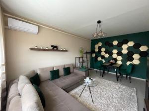 德布勒森Bella Apartman Debrecen的客厅配有沙发和桌子