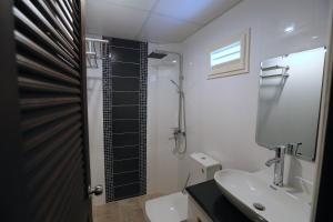 芭堤雅市中心卡特斯里楼酒店的浴室配有卫生间、盥洗盆和淋浴。