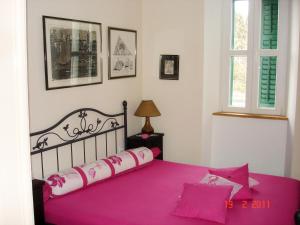布拉采Apartments by the sea Blace, Neretva Delta - Usce Neretve - 16068的一间卧室配有一张粉红色床单