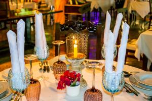 马林迪非洲度假别墅酒店的一张桌子,上面放着酒杯和蜡烛