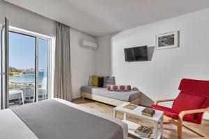 阿基欧斯尼古拉斯Blu Acqua Hotel的酒店客房设有床、沙发和窗户。