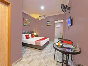 珍南海滩OYO Home 90348 Inspire Rooms的卧室配有一张床和一张桌子