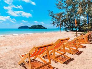 麦岛TK Beach Resort Koh Mak的坐在海滩上的一排椅子