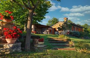 ŠmarjeHouse in Istria in pristine nature的院子中一棵树和鲜花的房子