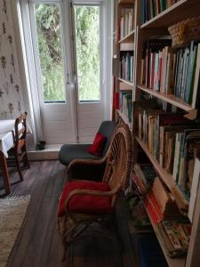 鹿特丹Residentie Blijdorp的一间设有两把椅子的房间和一个带书籍的书架