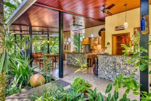 别霍港Villas Piña - Adults only的植物房屋的户外厨房和用餐区