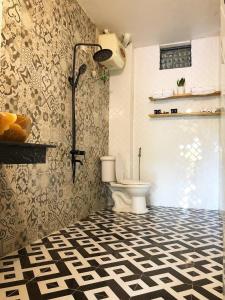 木州县Thênh Thang Home & Cafe的一间带卫生间的浴室,铺有黑白地板。