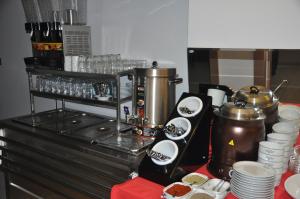 伊斯帕尔KOÇ OTEL ELİT TERMİNAL的厨房配有带咖啡壶和餐具的柜台