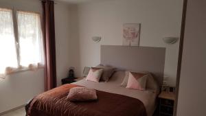 阿梅利莱班帕拉勒达T2 Tout Confort的卧室配有一张带粉红色枕头的大床