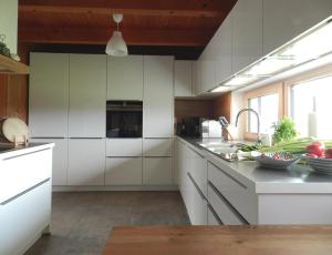 GrasbergDas Grasberghaus的厨房配有白色橱柜和水槽