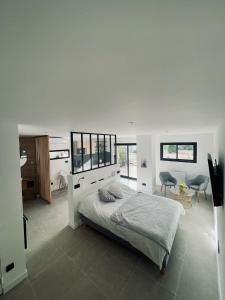 马赛La suite provençale的白色卧室配有床和桌椅