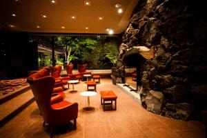 轻井泽王子轻井泽酒店的一间设有椅子和石墙的等候室