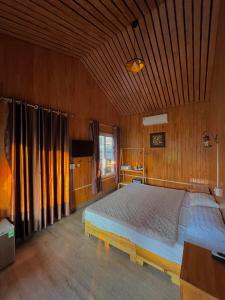 吉婆岛Catba Oasis Bungalows的木制客房内的一间卧室配有一张大床