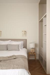 马德里DELUXE APARTMENT NEAR GRAN VIA的一间卧室配有一张床和一张带台灯的桌子