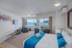 怀蒂昂格怀蒂昂格海滨公寓式酒店的一间带大床的卧室和一间客厅