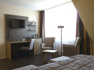 明斯特叶兰特鲁普酒店的酒店客房设有一张床、一张书桌和一台电视机。