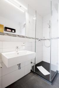 UnterrothGasthof Linde - Hotel Blum的白色的浴室设有水槽和淋浴。