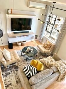 约翰内斯堡Nal'enzo Luxe Stays的带沙发和电视的客厅