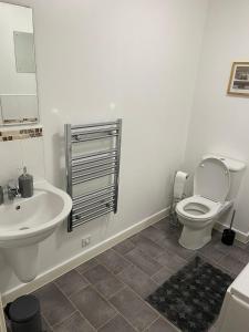 伍尔弗汉普顿Remarkable 2-Bed Apartment in Wolverhampton的白色的浴室设有卫生间和水槽。
