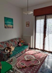 维韦罗内Appartamento doppi bagni sei posti letto的客厅里设有绿沙发,里面装有填充物的动物