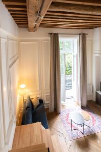 里昂Le Chavannes -Ecrin élégant & Cosy - Pentes de la Croix Rousse的客厅配有蓝色的沙发和桌子