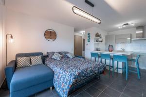 GroisyCabana & La Terrasse du Parmelan proche Annecy的一间带蓝色床的卧室和一间厨房